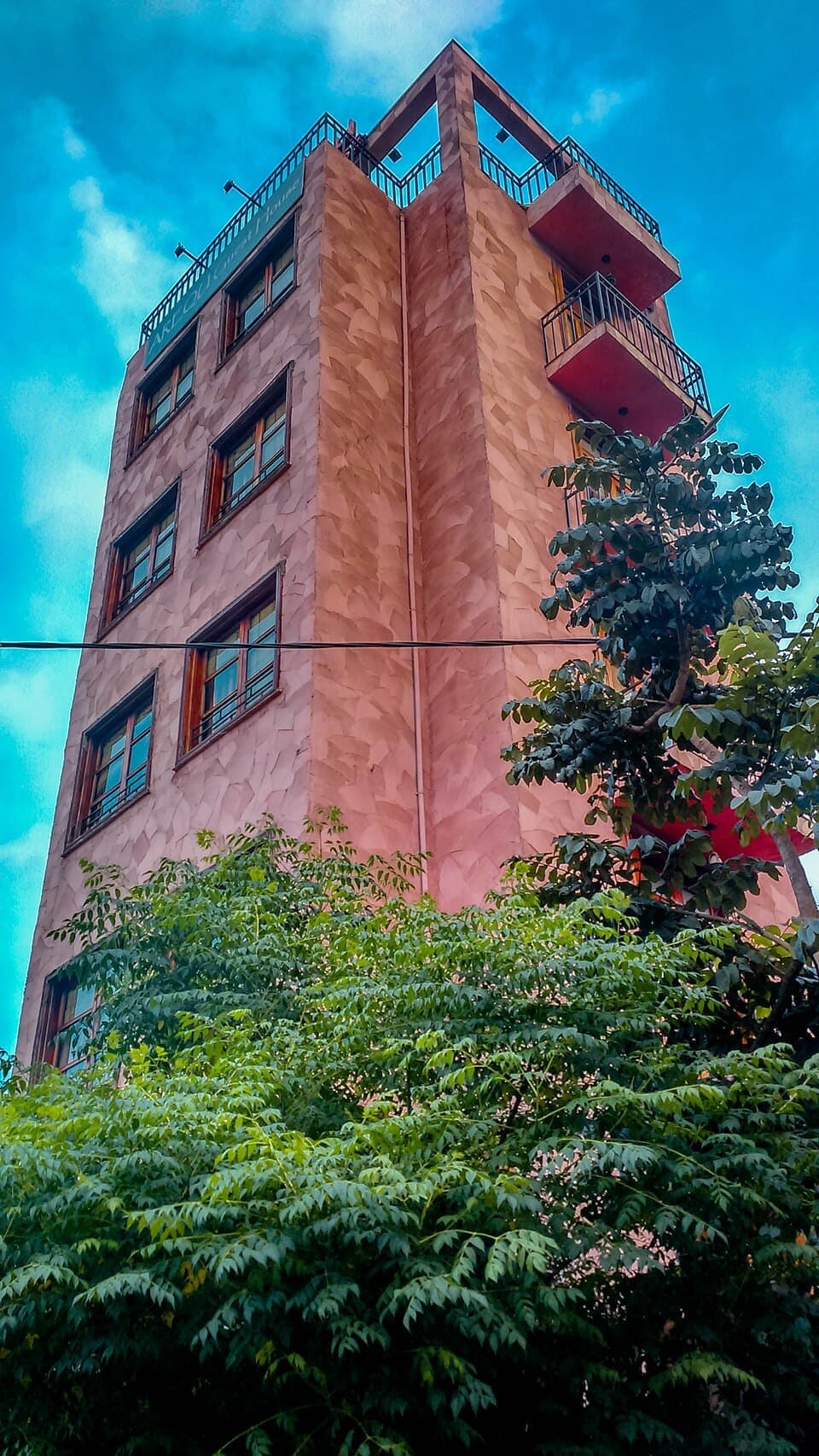 This image shows a five story building whose formal language is derived from St. Giorgis Church whic